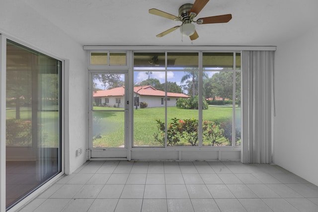 unfurnished sunroom with ceiling fan and plenty of natural light