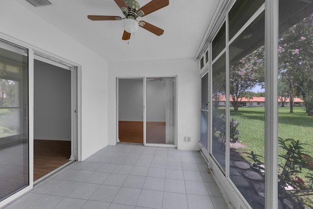 unfurnished sunroom featuring ceiling fan