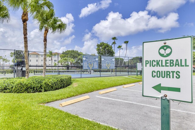 view of community featuring tennis court