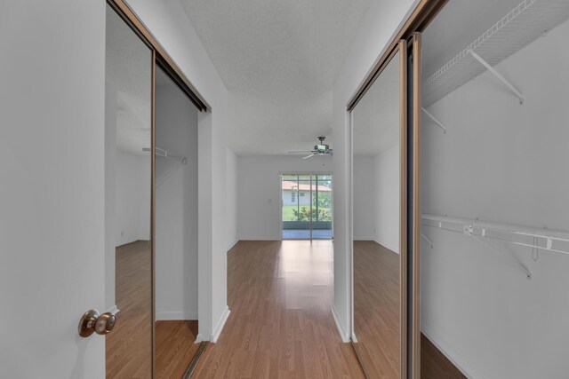 corridor with light wood-type flooring