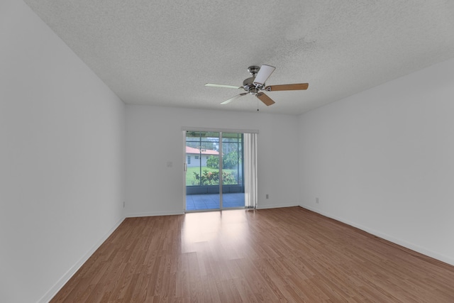 unfurnished room featuring ceiling fan, wood-type flooring, and a textured ceiling