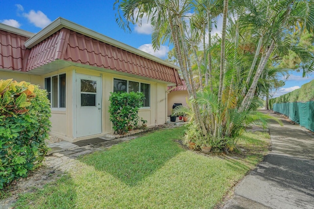 view of side of property with a yard