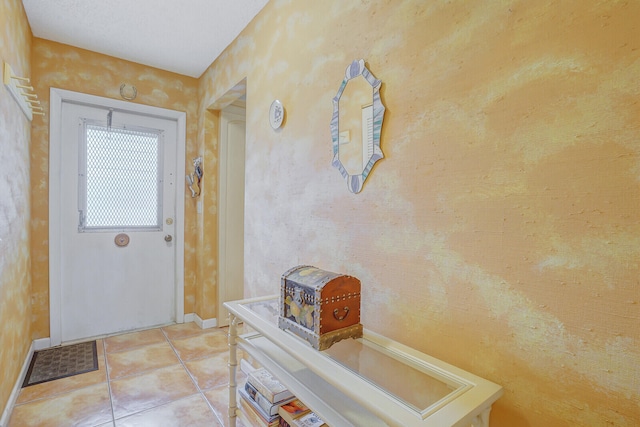 doorway with light tile patterned floors