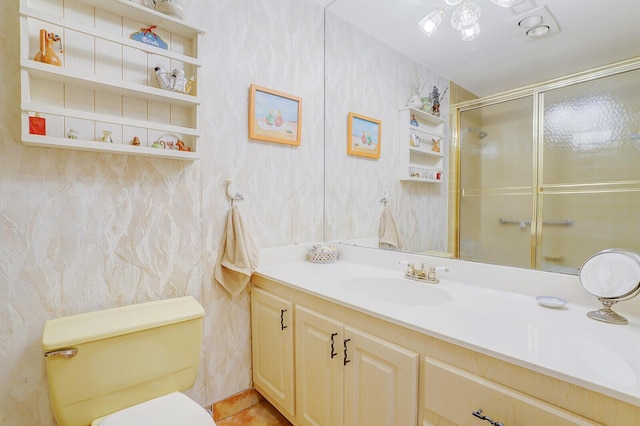 bathroom with walk in shower, vanity, and toilet