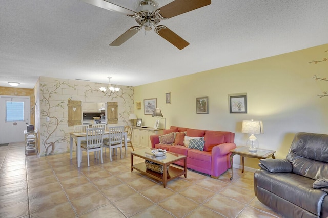 tiled living room featuring ceiling fan with notable chandelier and a textured ceiling