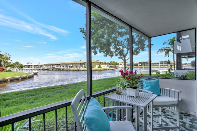 sunroom / solarium with a water view