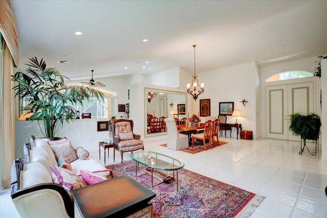 living room with ceiling fan with notable chandelier and light tile patterned floors