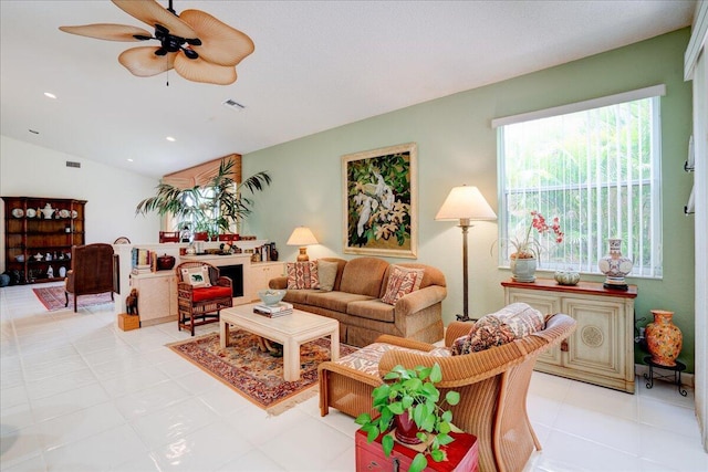 tiled living room featuring ceiling fan