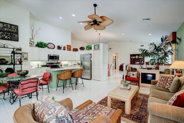 living room featuring light tile patterned flooring, high vaulted ceiling, and ceiling fan