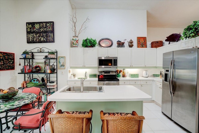 kitchen featuring sink, light tile patterned flooring, white cabinetry, and stainless steel appliances