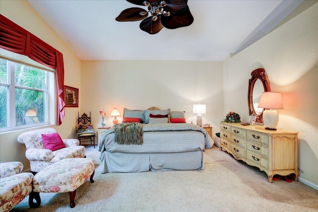 carpeted bedroom with vaulted ceiling and ceiling fan