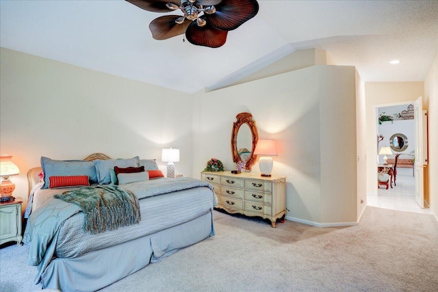 carpeted bedroom featuring lofted ceiling and ceiling fan