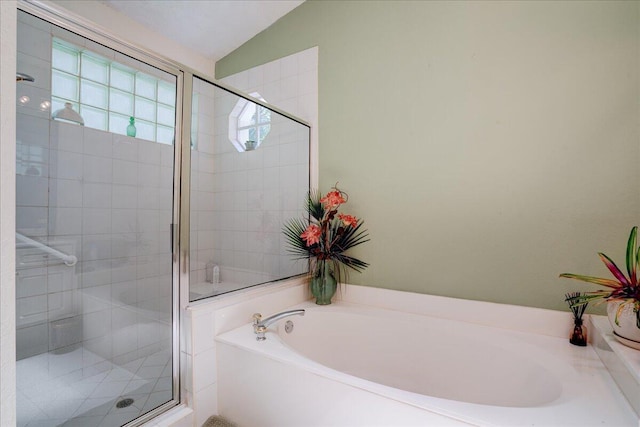 bathroom with shower with separate bathtub and vaulted ceiling