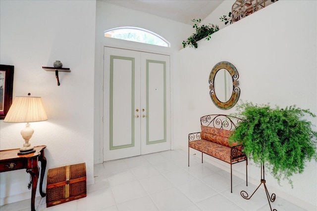 foyer featuring vaulted ceiling and light tile patterned floors