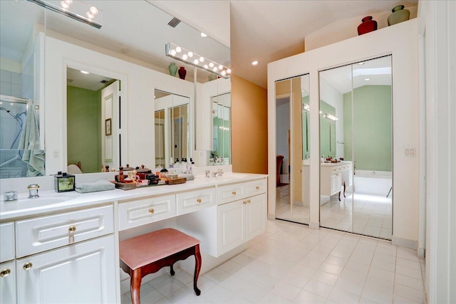 bathroom with tile patterned flooring, a tub, vaulted ceiling, and dual bowl vanity