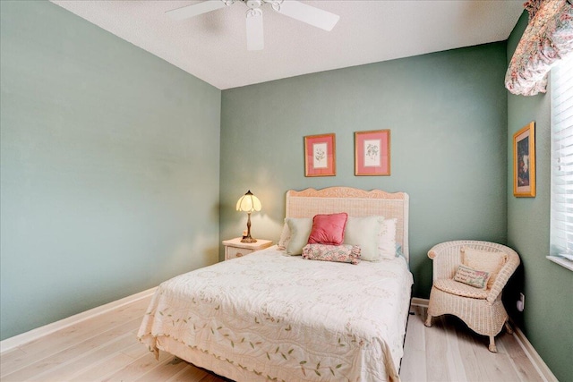 bedroom with light wood-type flooring and ceiling fan