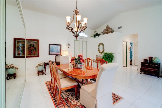 dining room with light tile patterned floors, high vaulted ceiling, and a chandelier