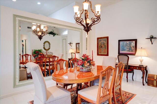 tiled dining area with vaulted ceiling and an inviting chandelier