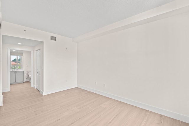 spare room featuring light hardwood / wood-style flooring