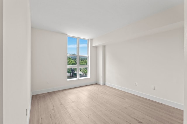 empty room with light hardwood / wood-style flooring