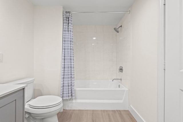 full bathroom featuring shower / bath combo with shower curtain, vanity, and toilet