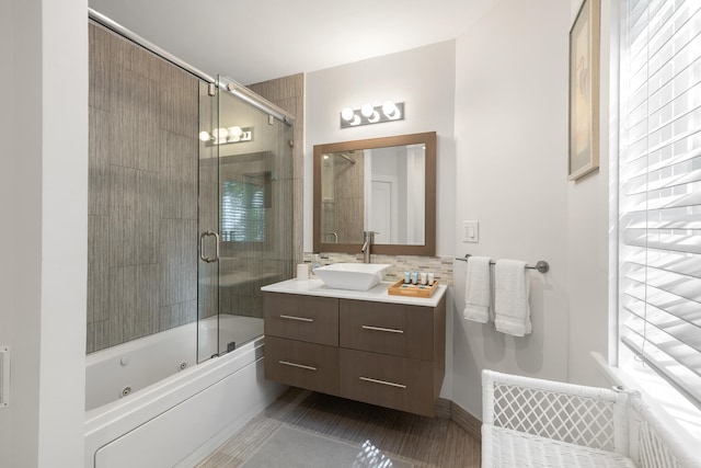 bathroom with bath / shower combo with glass door and vanity