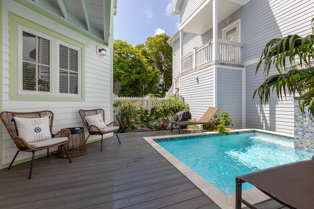 view of swimming pool featuring a deck