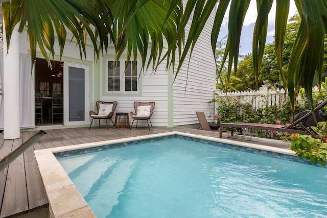 view of swimming pool with a deck