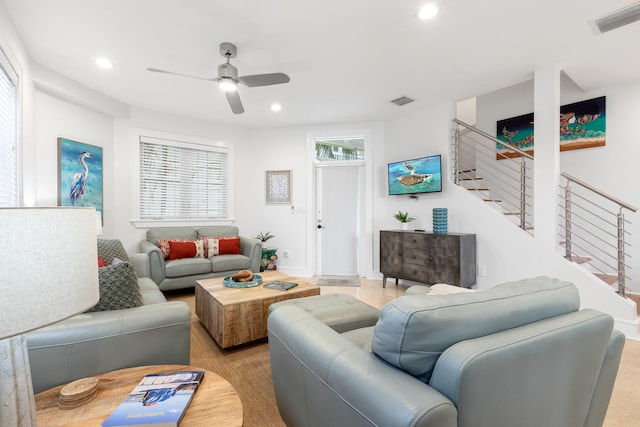 living room featuring ceiling fan and light wood-type flooring