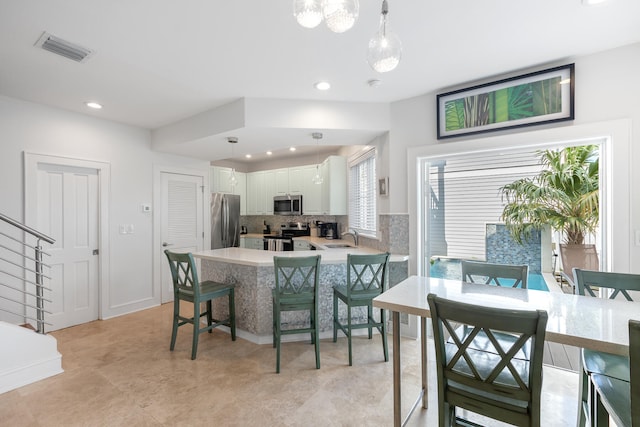 tiled dining room featuring sink