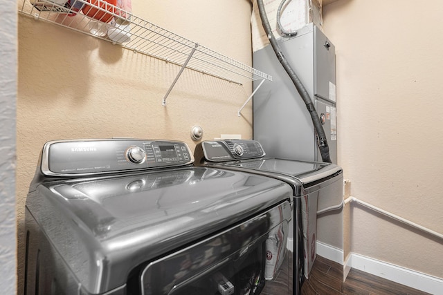 7869 Laina Ln Unit 2, Boynton Beach, FL 33437 - laundry room with separate washer and dryer, baseboards, dark wood finished floors, and heating unit