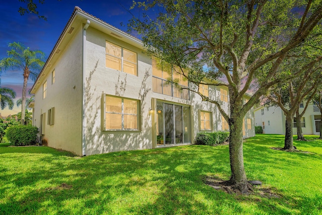 7869 Laina Ln Unit 2, Boynton Beach, FL 33437 - rear view of property with stucco siding and a yard