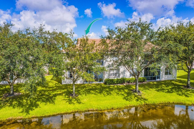 7869 Laina Ln Unit 2, Boynton Beach, FL 33437 - rear view of property featuring a yard and a water view