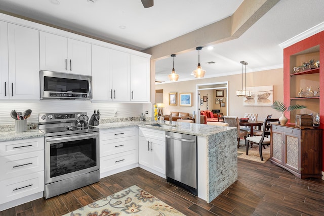 7869 Laina Ln Unit 2, Boynton Beach, FL 33437 - kitchen with appliances with stainless steel finishes, a peninsula, a sink, crown molding, and white cabinetry