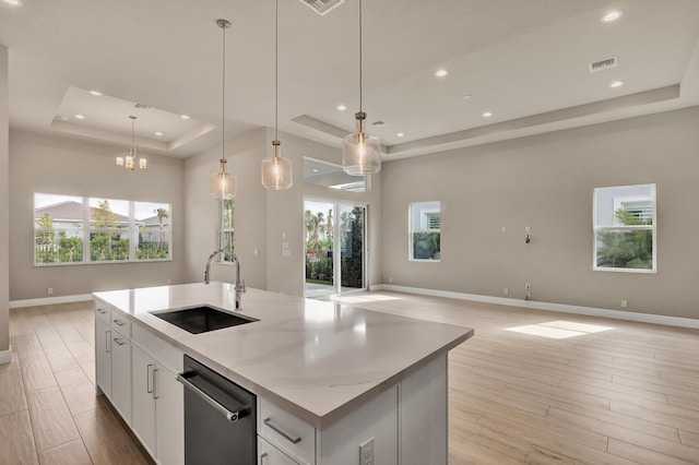 kitchen featuring a healthy amount of sunlight, white cabinetry, and sink