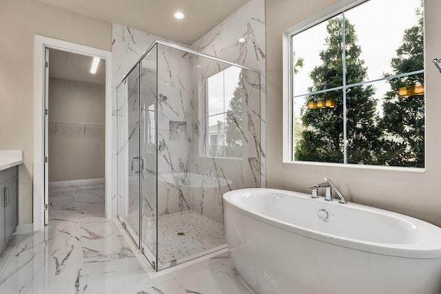 bathroom with vanity, a healthy amount of sunlight, and shower with separate bathtub