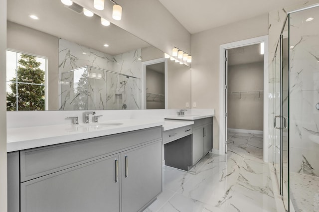 bathroom with vanity and a shower with door