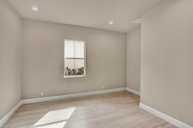 unfurnished room with light wood-type flooring