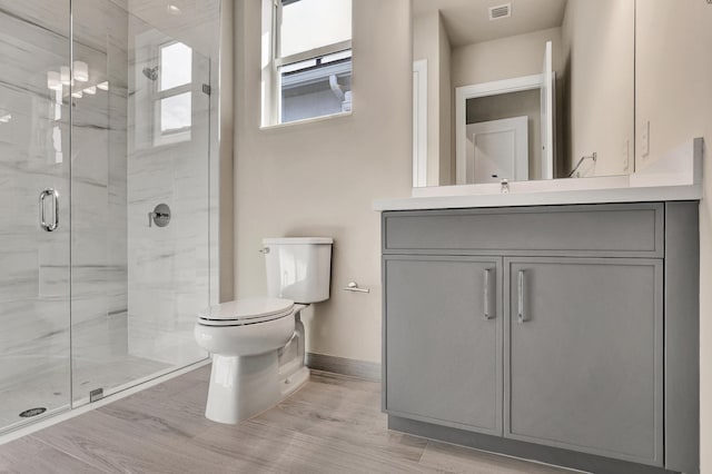 bathroom with vanity, wood-type flooring, an enclosed shower, and toilet