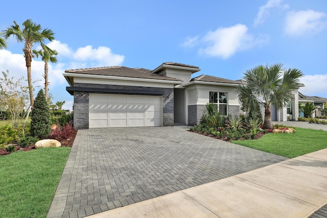 prairie-style house with a garage and a front yard