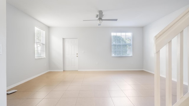 2156 SE Eatonville Dr, Port Saint Lucie, FL 34952 - unfurnished room featuring light tile patterned flooring, baseboards, and a ceiling fan