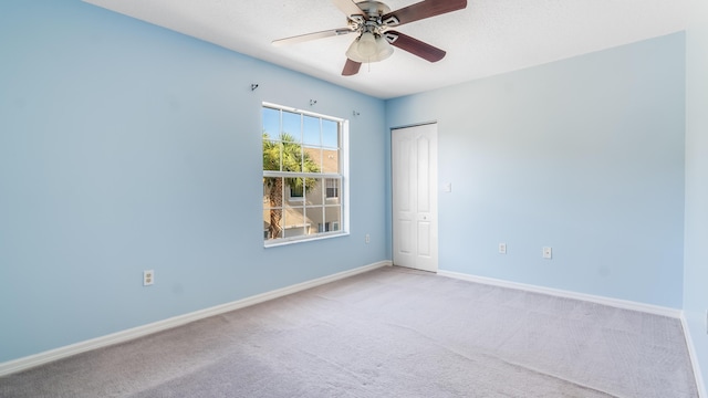 2156 SE Eatonville Dr, Port Saint Lucie, FL 34952 - empty room with carpet floors, baseboards, and a ceiling fan