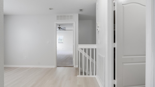 2156 SE Eatonville Dr, Port Saint Lucie, FL 34952 - corridor with an upstairs landing, light wood finished floors, and visible vents