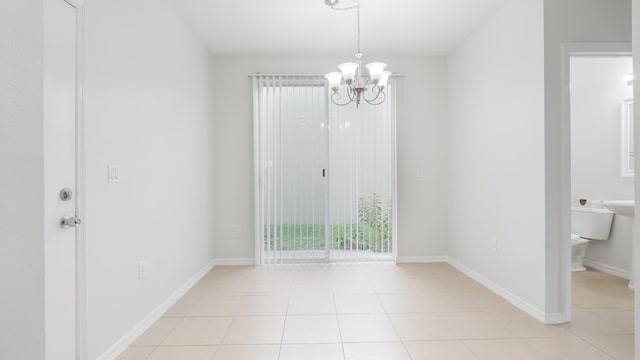 2156 SE Eatonville Dr, Port Saint Lucie, FL 34952 - unfurnished dining area featuring baseboards, a notable chandelier, and light tile patterned flooring