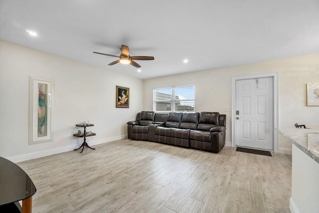 living room featuring light wood-type flooring and ceiling fan