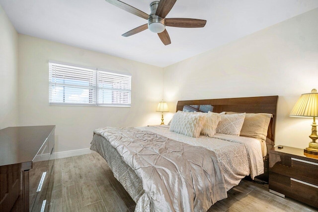 bedroom with hardwood / wood-style flooring and ceiling fan