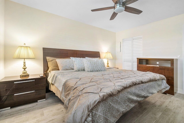 bedroom with ceiling fan and light hardwood / wood-style floors