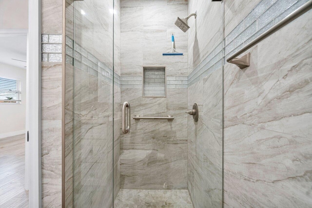 bathroom featuring an enclosed shower and wood-type flooring