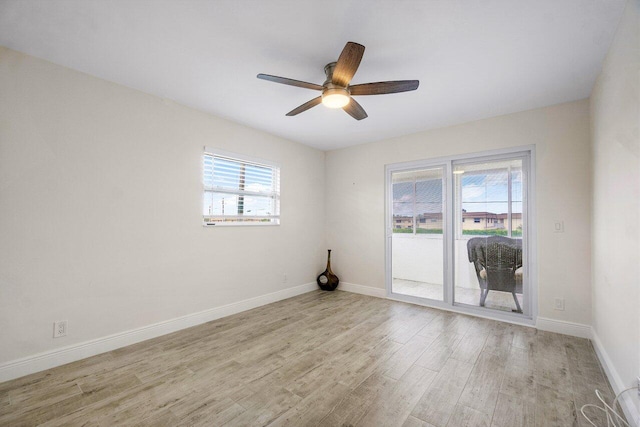 empty room with ceiling fan and light hardwood / wood-style flooring