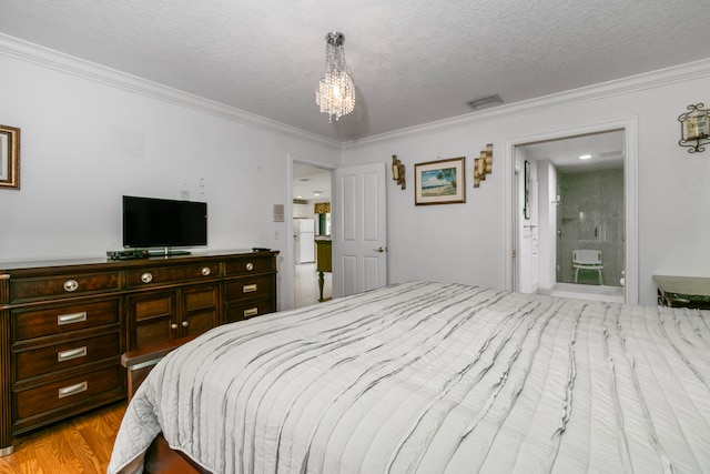 bedroom with a textured ceiling, light wood-type flooring, ornamental molding, and an inviting chandelier